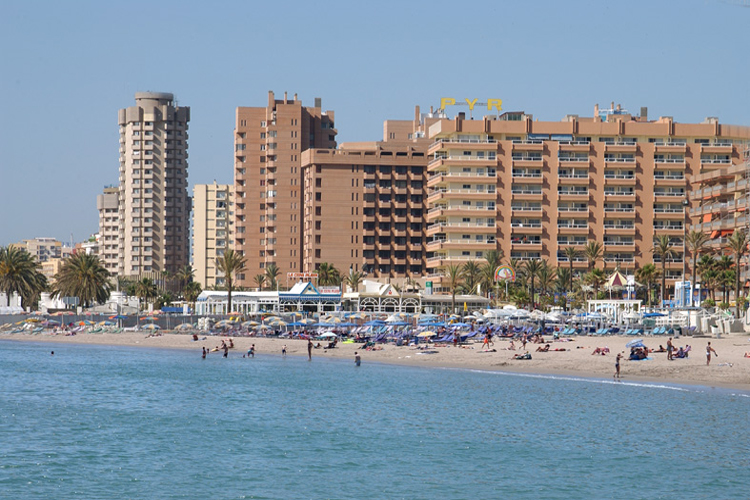 The Hotel PYR in Fuengirola as seen from the sea with holidaymakers on the beach.