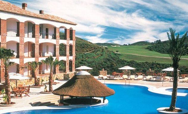 The La Cala Hotel with swimming pool and hotel in the foreground and the golf course behind.