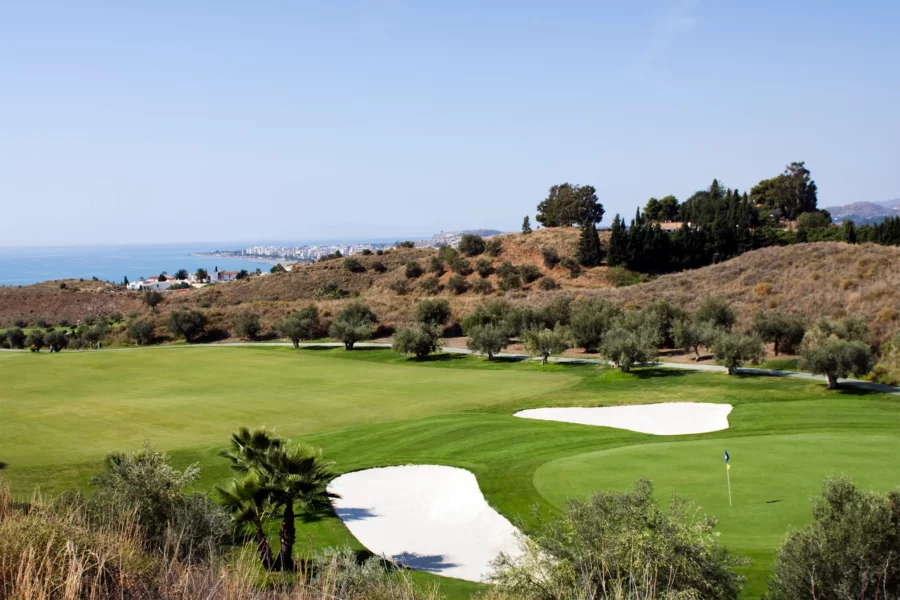 One of the greens at Baviera with distant sea views.