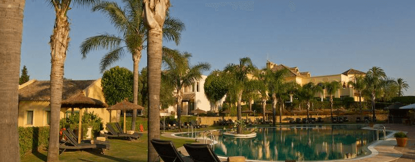 Almenara Golf Hotel swimming pool with lots of palm trees.
