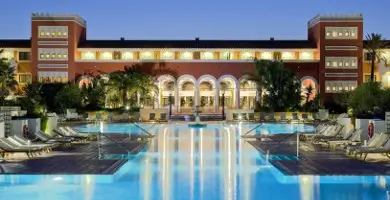View of the Melia Sancti hotel pool at night with the hotel in the background