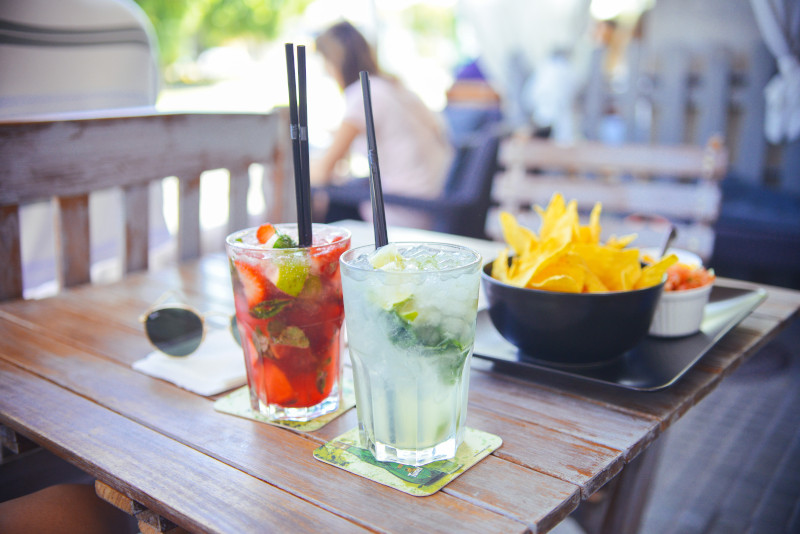 Cold drinks on table with potato chip snacks