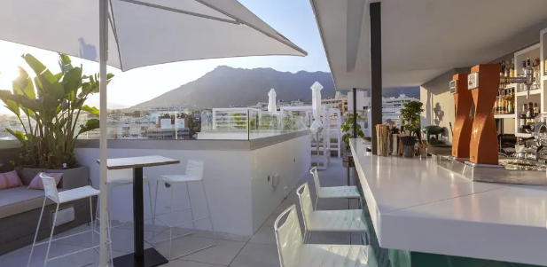 Bar at the Hotel Lima Marbella with mountain views in background.