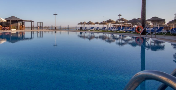 External pool at the Vik Grand Hotel La Cala with empty sun beds.